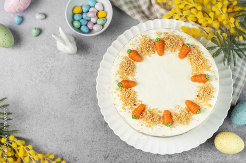 Homemade Easter carrot cake made with walnuts, iced with cream cheese. Sweet dessert.