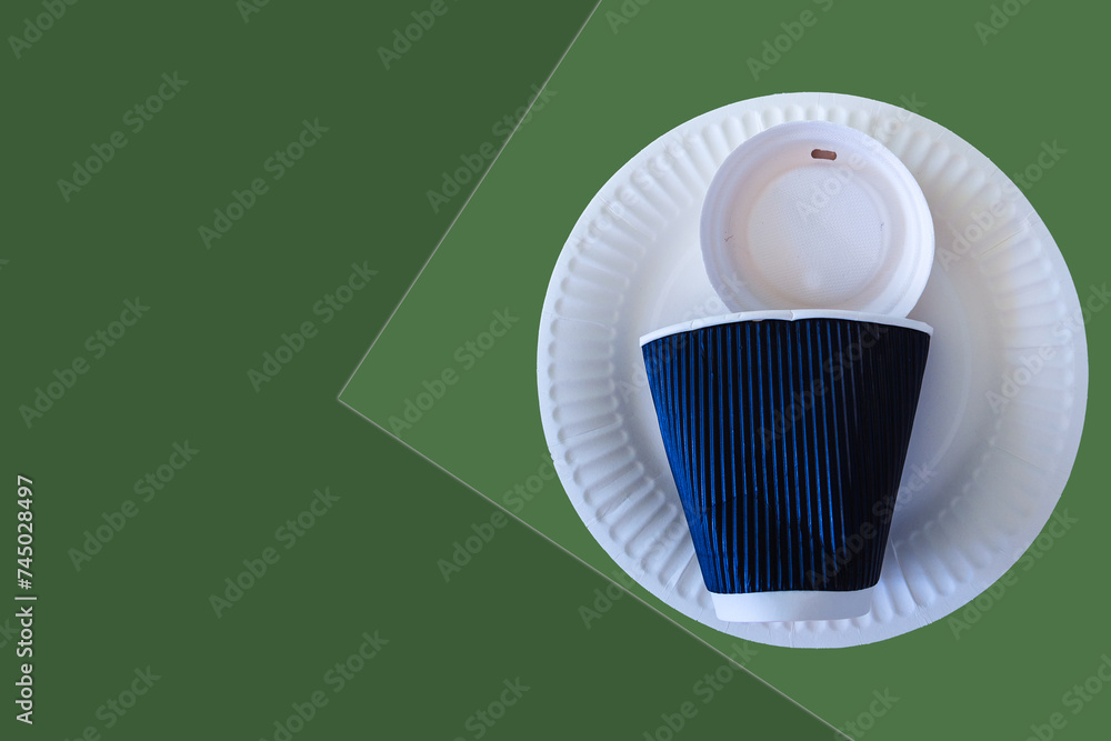 A set of disposable paper round plates and cup on green background. Eco friendly. A set of disposable paper round plates and cup on green background. Eco friendly.
