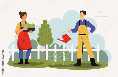 Agricultural employees working in garden with tools © Tartila