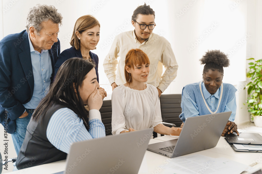Diverse team evaluating online project - Engaged employees sharing insights - Collaborative digital work analysis. Diverse team evaluating online project - Engaged employees sharing insights - Collaborative digital work analysis.