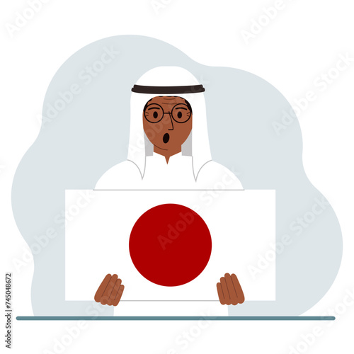 A man holds the flag of Japan in his hands. The concept of demonstration, national holiday or patriotism. Nationality.