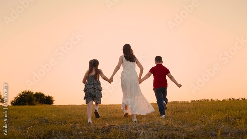 mother runs into sunset holding her son daughter hand, happy family running, boy girl, chasing dreams sunset, let's run, team adventure, creating wonderful show teamwork unity, our journey, kids