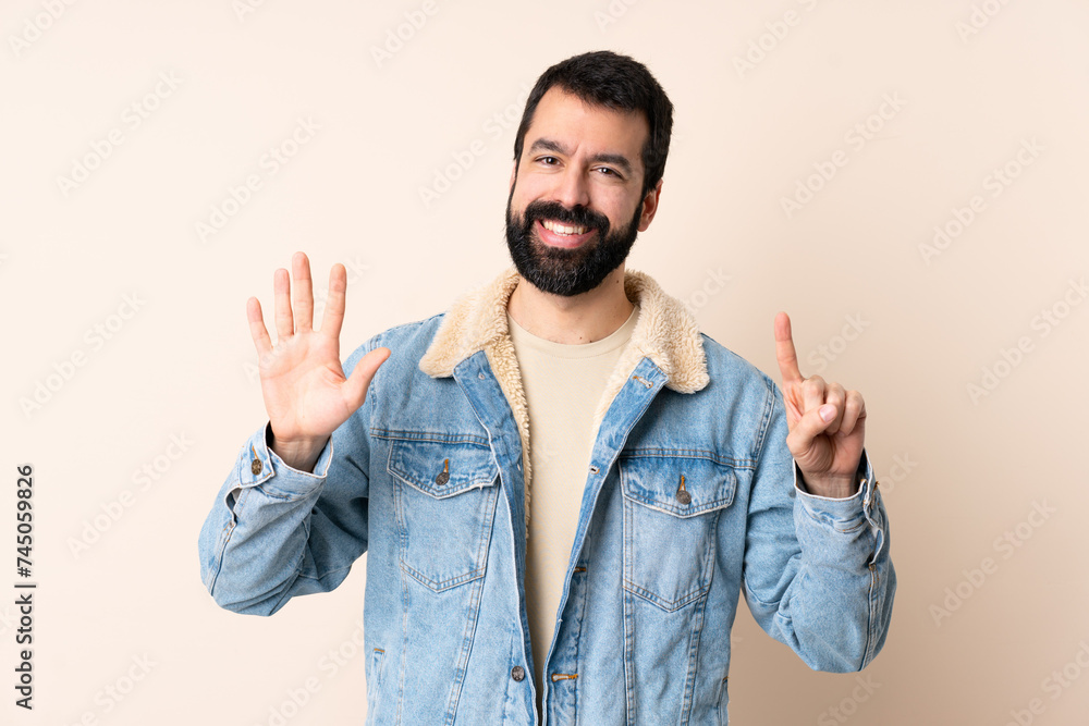 Caucasian man with beard over isolated background counting six with fingers Caucasian man with beard over isolated background counting six with fingers