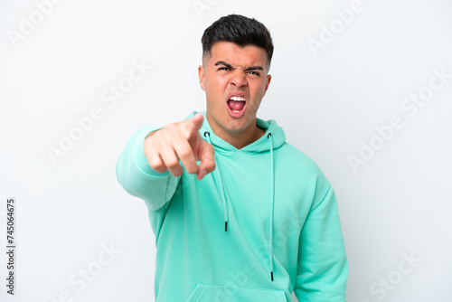 Young caucasian handsome man isolated on white background frustrated and pointing to the front © luismolinero