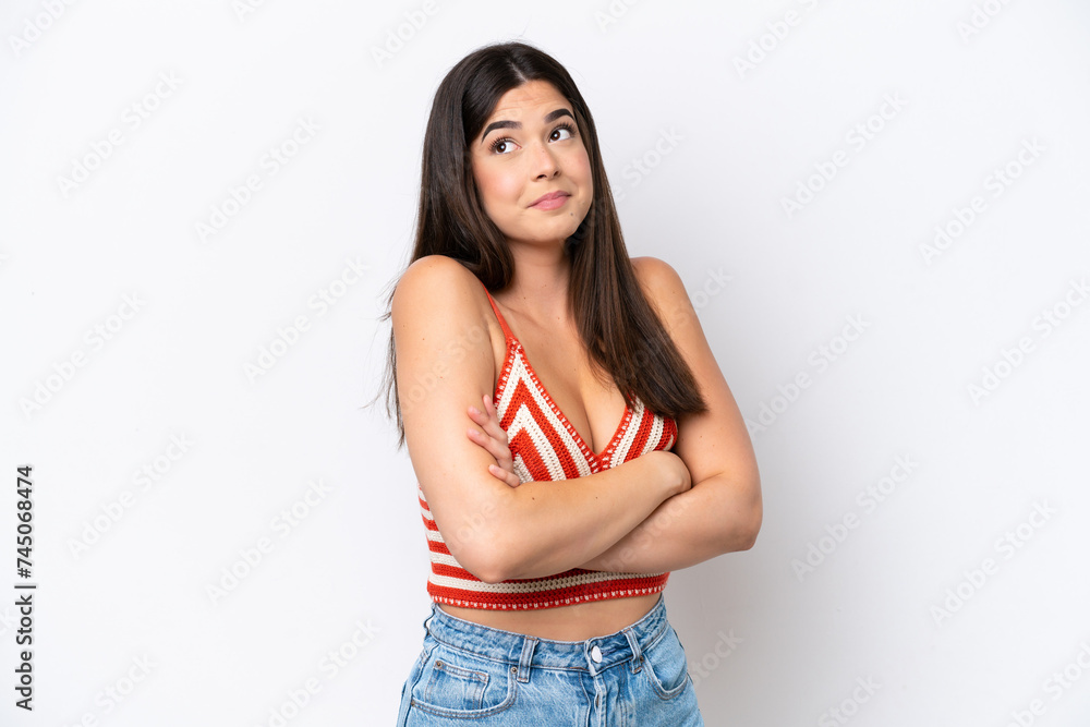 Young Brazilian woman isolated on white background making doubts gesture while lifting the shoulders Young Brazilian woman isolated on white background making doubts gesture while lifting the shoulders