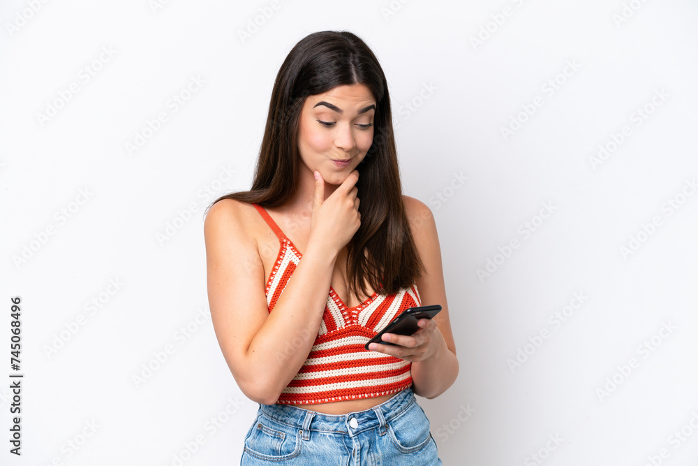 Young Brazilian woman isolated on white background thinking and sending a message Young Brazilian woman isolated on white background thinking and sending a message