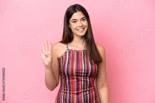Young Brazilian woman isolated on pink background happy and counting four with fingers