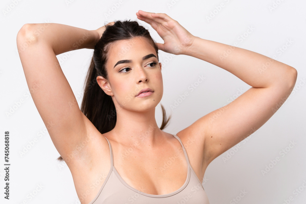 Young Brazilian woman isolated on white background touching her hair. Close up portrait