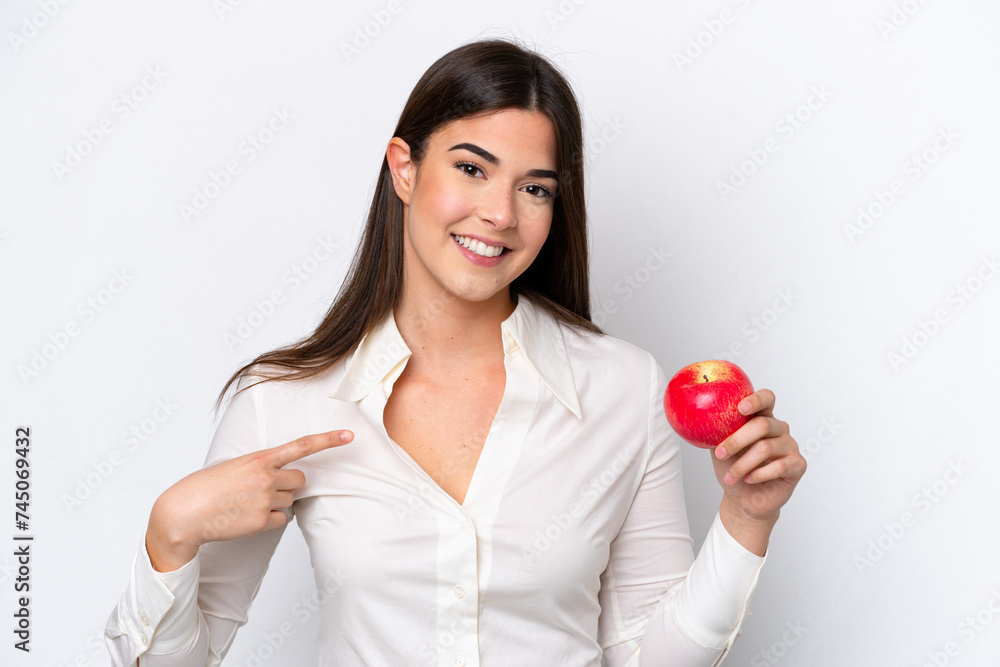 Young Brazilian woman with an apple isolated on white background with surprise facial expression Young Brazilian woman with an apple isolated on white background with surprise facial expression
