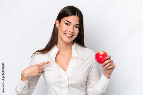 Young Brazilian woman with an apple isolated on white background with surprise facial expression