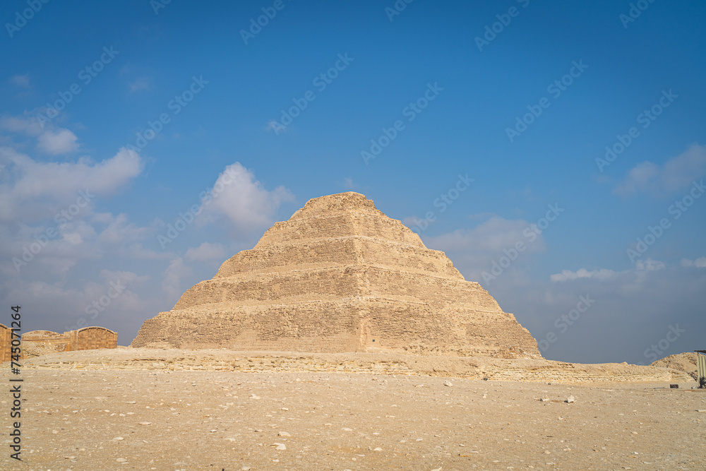 Cairo, Egypt - October 26, 2022. View of the scale pyramid of Djoser in the Saqqara necropolis. Cairo, Egypt - October 26, 2022. View of the scale pyramid of Djoser in the Saqqara necropolis.