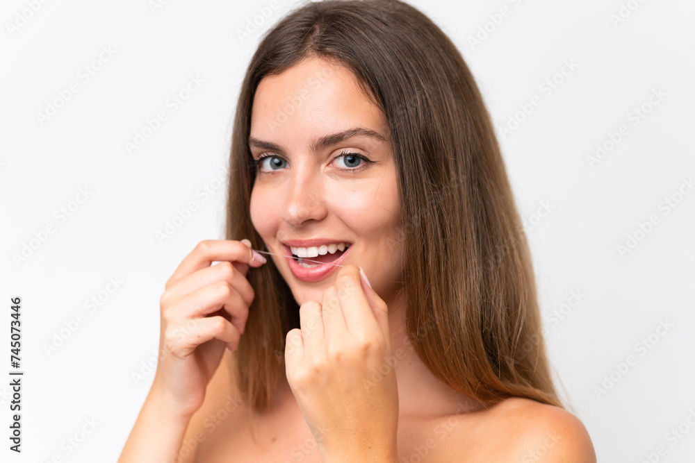 Young caucasian woman isolated on white background using dental floss with happy expression. Close up portrait Young caucasian woman isolated on white background using dental floss with happy expression. Close up portrait