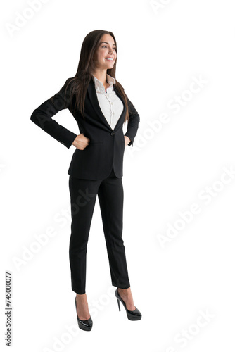 Smiling businesswoman with hand on hip, black suit, isolated on white. Confident professional pose