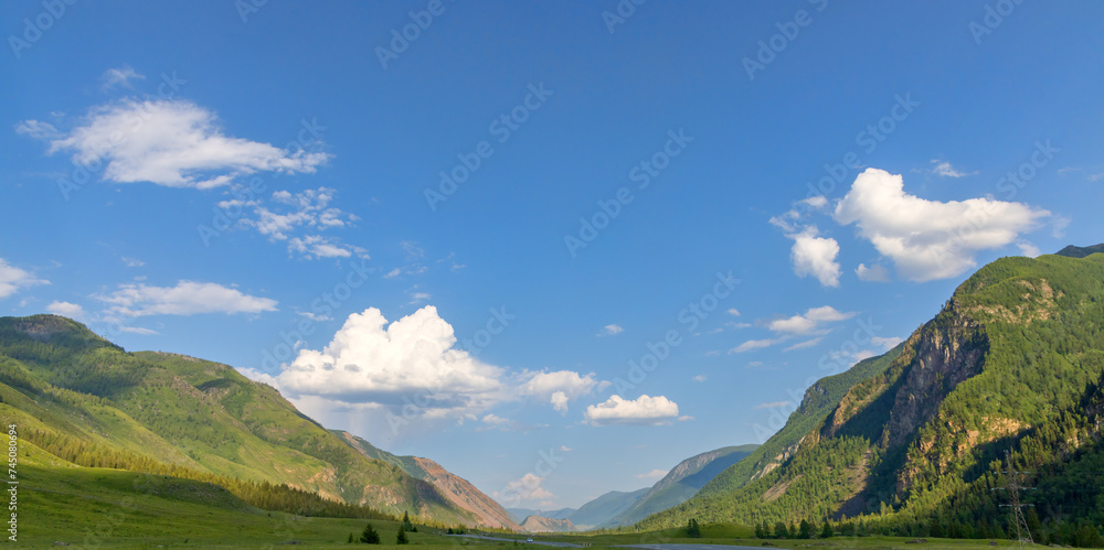 Altai mountains under blue sky and small clouds panorama