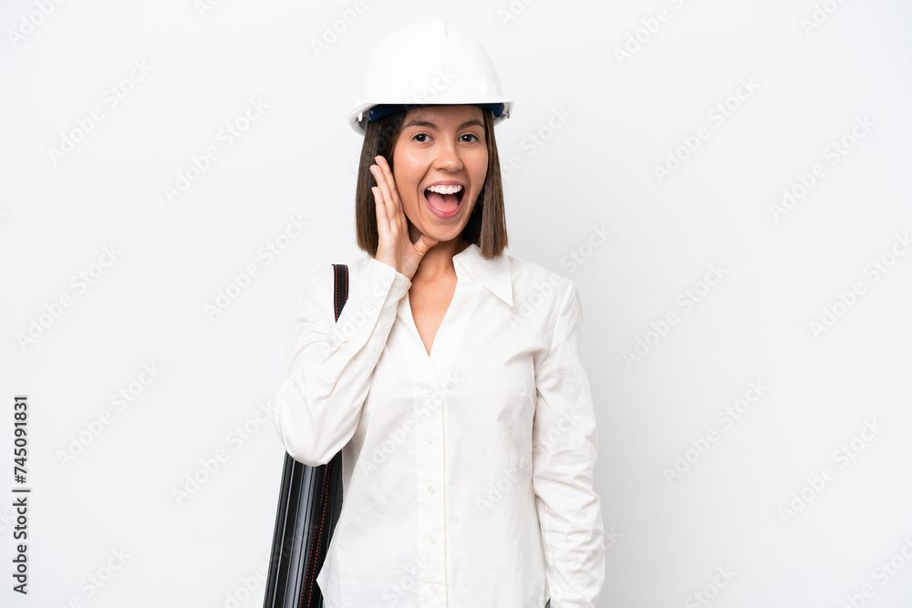 Young architect woman with helmet and holding blueprints isolated on white background with surprise and shocked facial expression Young architect woman with helmet and holding blueprints isolated on white background with surprise and shocked facial expression