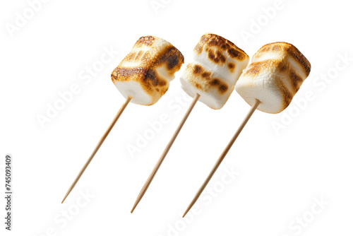 marshmallow skewers floating, emphasizing the golden brown roasting effect.