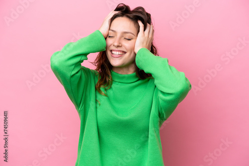 Young caucasian woman isolated on pink background laughing © luismolinero