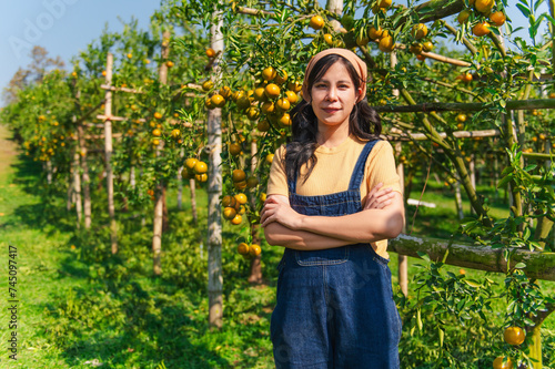 woman orchard woman stands with her arms crossed in the orange orchard with confidence