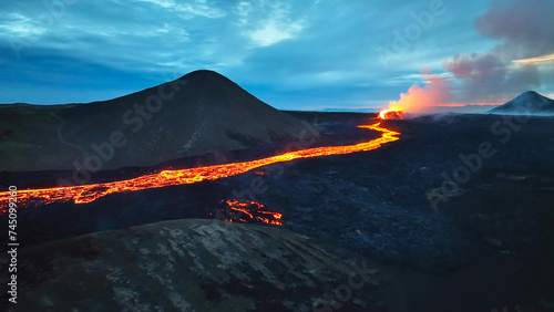 Aerial view over volcanic eruption, Night view, Mount Fagradalsfjall lava spill out of the crater Mount Fagradalsfjall, July 2023, Iceland. Impressive aerial View of the active volcano explosions