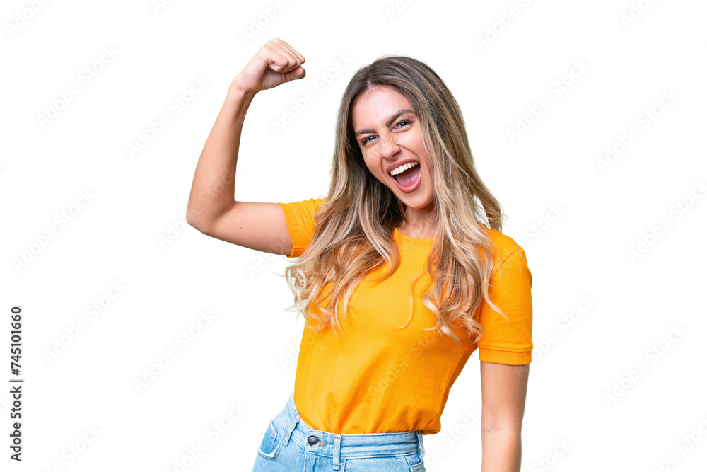 Young Uruguayan woman over isolated background celebrating a victory - obrazy, fototapety, plakaty 