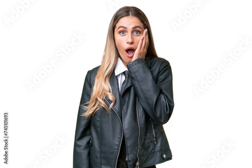 Business pretty Uruguayan woman wearing a biker jacket over isolated background with surprise and shocked facial expression