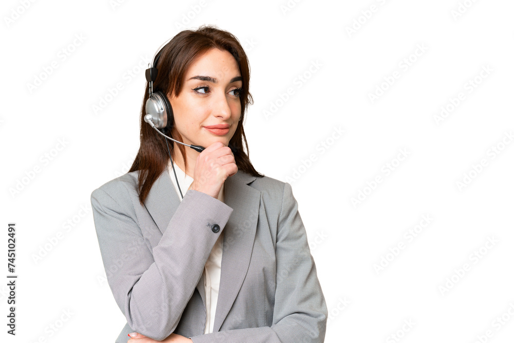Telemarketer caucasian woman working with a headset over isolated chroma key background looking to the side Telemarketer caucasian woman working with a headset over isolated chroma key background looking to the side