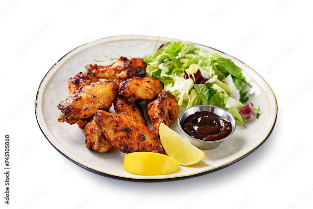 Air fryer chicken wings with fresh green salad, barbecue sauce and lemon slices. isolated on white background Air fryer chicken wings with fresh green salad, barbecue sauce and lemon slices. isolated on white background
