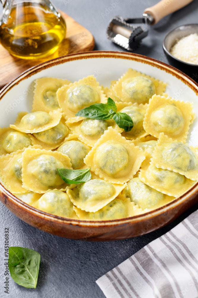 Homemade Ravioli pasta with spinach and ricotta cheese filling with olive oil and grated Parmesan cheese. Homemade Ravioli pasta with spinach and ricotta cheese filling with olive oil and grated Parmesan cheese.