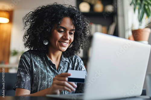 girl using her credit card to buy with her laptop photo