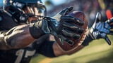 receivers glove in close-up on a recivers hand on football field, holding a football, sports photography