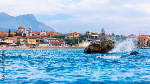 Adriatic sea and waves with village in the background- Travel destination, tour tourism in Croatia or Greece