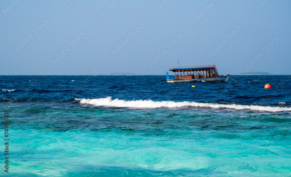 A brown wooden ship floats on the sea. Sunny weather. A brown wooden ship floats on the sea. Sunny weather.