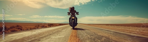 open road, the motorcyclist embraces the exhilarating freedom of the journey. With the powerful roar of the motorcycle engine and the wind rushing past photo