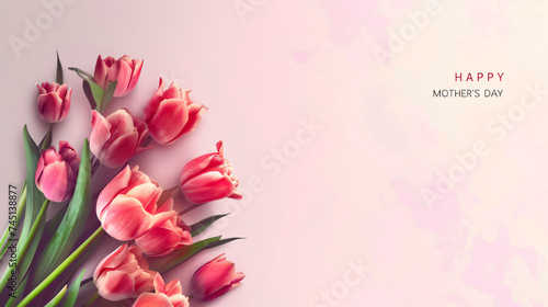 bouquet of tulips on pink background with happy mothers day wish card
