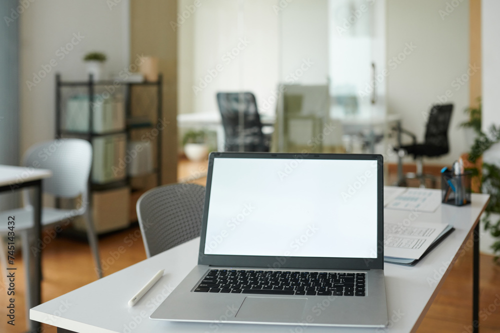 Opened laptop with empty screen on office desk of startupper Opened laptop with empty screen on office desk of startupper