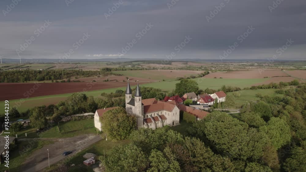 Drone flight in autumn over a small village in Munchenlochra Germany. The fields are yellow and green and the sun is going down. Drone flight in autumn over a small village in Munchenlochra Germany. The fields are yellow and green and the sun is going down.