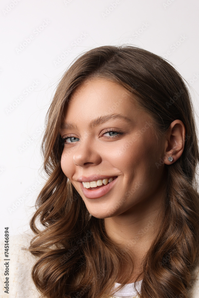 Beautiful young girl with fresh healthy skin. Woman advertise ear-rings. White background. Earrings closeup. Blond european woman with long hair with big lips, pretty smile. Cosmetology, scincare. Beautiful young girl with fresh healthy skin. Woman advertise ear-rings. White background. Earrings closeup. Blond european woman with long hair with big lips, pretty smile. Cosmetology, scincare.