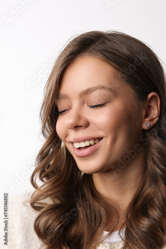 Beautiful young girl with fresh healthy skin. Woman advertise ear-rings. White background. Earrings closeup. Blond european woman with long hair with big lips  pretty smile. Cosmetology  scincare. 