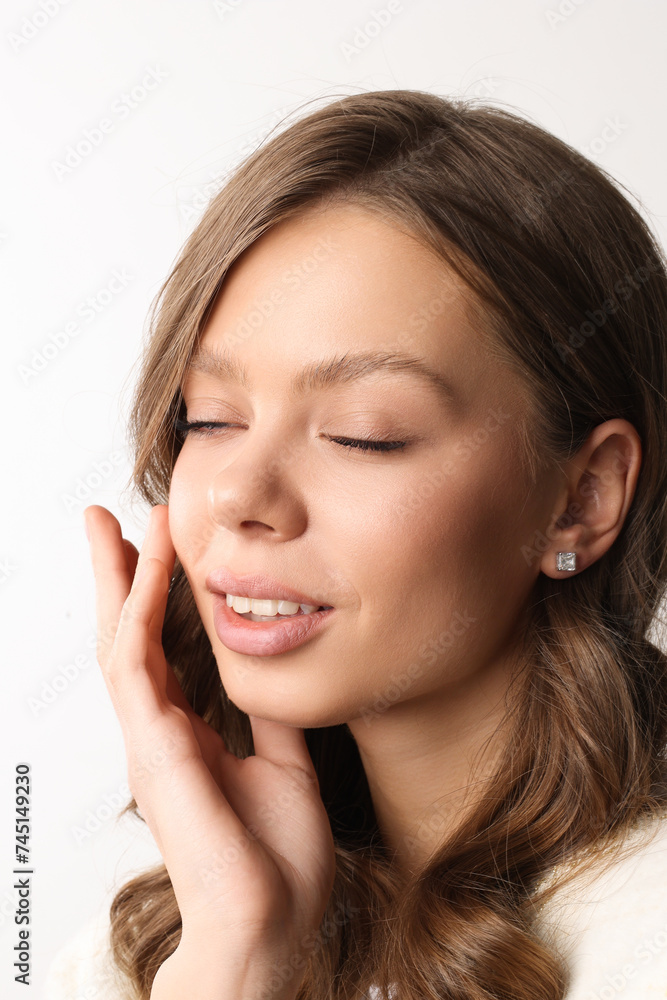 Beautiful young girl with fresh healthy skin. Woman advertise ear-rings. White background. Earrings closeup. Blond european woman with long hair with big lips, pretty smile. Cosmetology, scincare Beautiful young girl with fresh healthy skin. Woman advertise ear-rings. White background. Earrings closeup. Blond european woman with long hair with big lips, pretty smile. Cosmetology, scincare