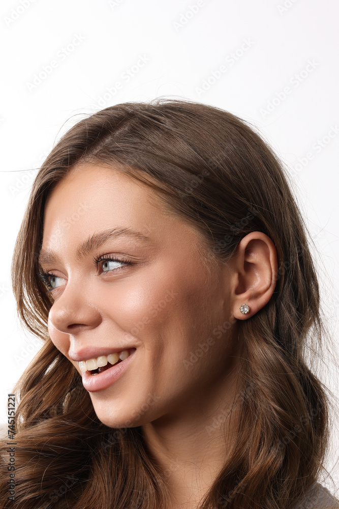 Beautiful young girl with fresh healthy skin. Woman advertise ear-rings. White background. Earrings closeup. Blond european woman with long hair with big lips, pretty smile. Cosmetology, scincare Beautiful young girl with fresh healthy skin. Woman advertise ear-rings. White background. Earrings closeup. Blond european woman with long hair with big lips, pretty smile. Cosmetology, scincare