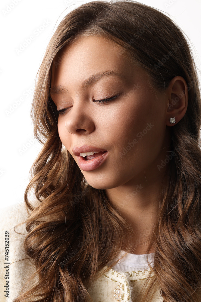 Beautiful young girl with fresh healthy skin. Woman advertise ear-rings. White background. Earrings closeup. Blond european woman with long hair with big lips, pretty smile. Cosmetology, scincare