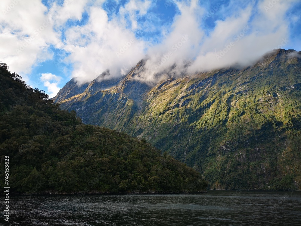 Fiordland National park with stunning views over the mountains covered with clouds.