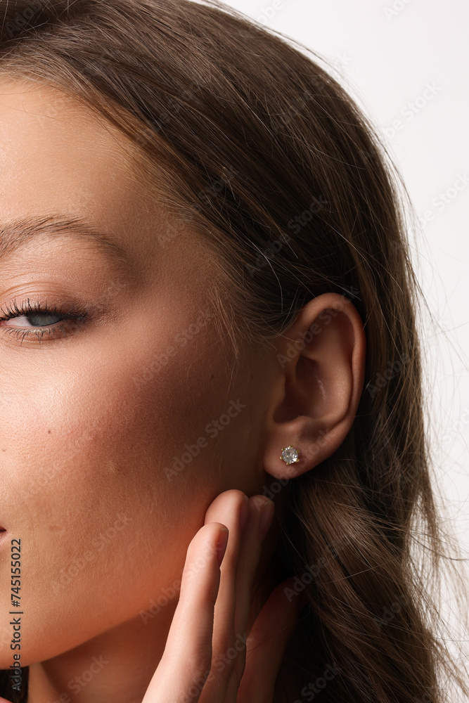 Beautiful young girl with fresh healthy skin. Woman advertise ear-rings. White background. Earrings closeup. Blond european woman with long hair with big lips, pretty smile. Cosmetology, scincare Beautiful young girl with fresh healthy skin. Woman advertise ear-rings. White background. Earrings closeup. Blond european woman with long hair with big lips, pretty smile. Cosmetology, scincare