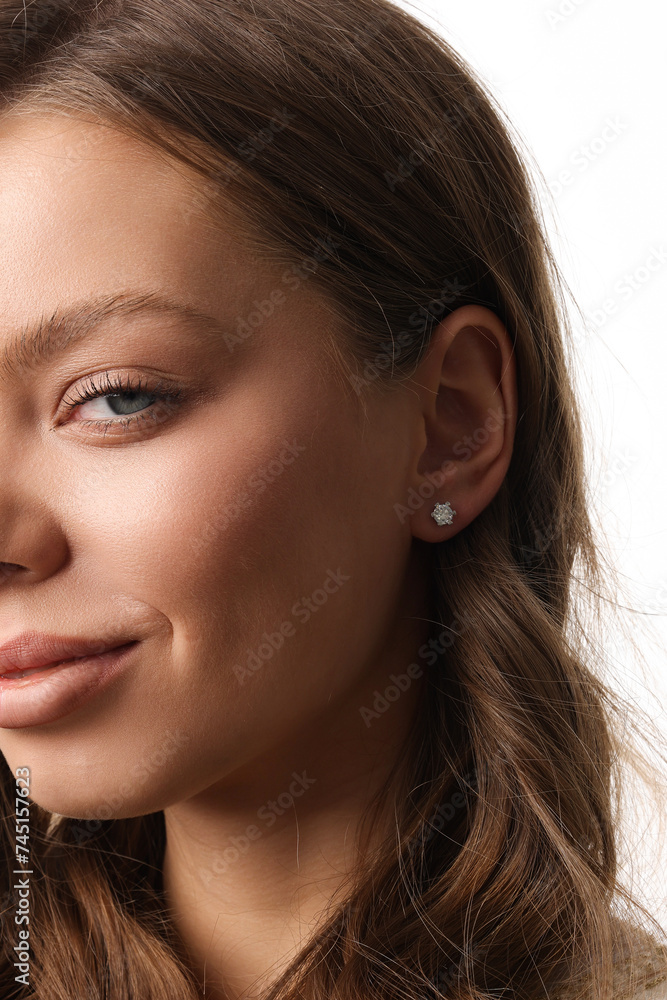 Beautiful young girl with fresh healthy skin. Woman advertise ear-rings. White background. Earrings closeup. Blond european woman with long hair with big lips, pretty smile. Cosmetology, scincare Beautiful young girl with fresh healthy skin. Woman advertise ear-rings. White background. Earrings closeup. Blond european woman with long hair with big lips, pretty smile. Cosmetology, scincare