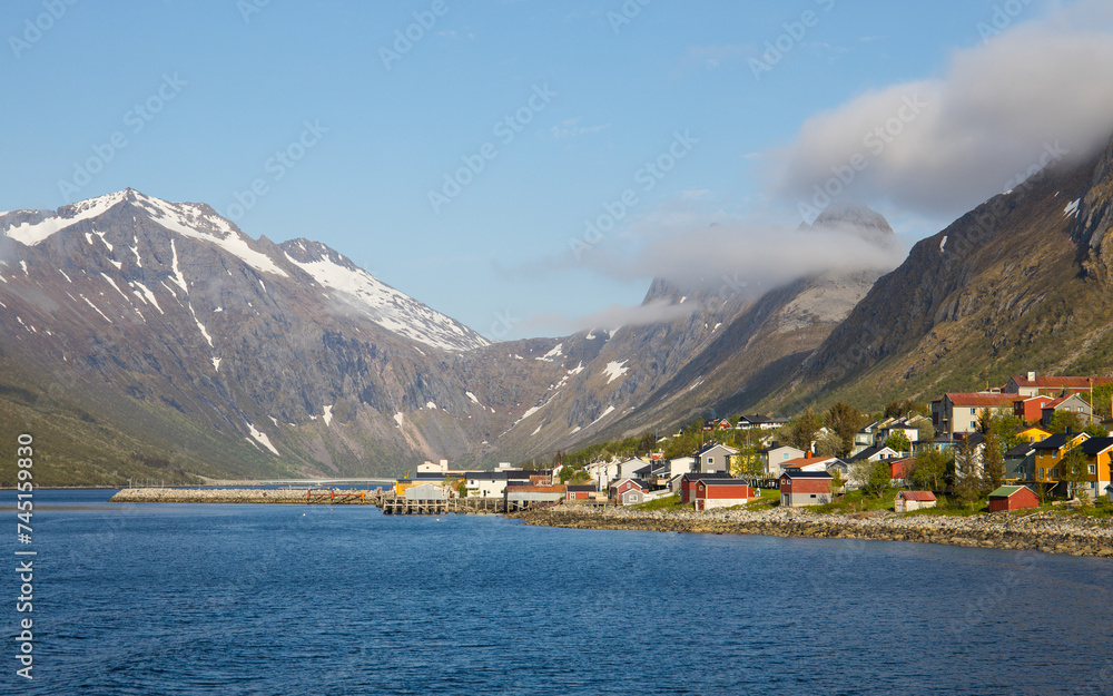 Dramatic landscape with typical norwegian fishing village in the Grillefjord, located at island Senja in Norway