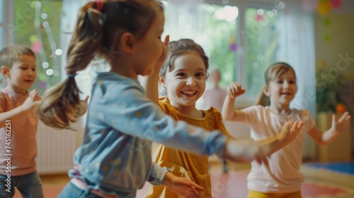 Toddlers Dancing Happily Together at Nursery School photo