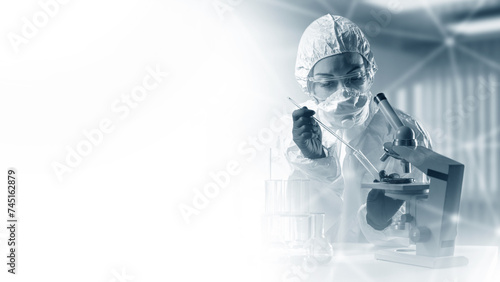 Medical laboratory specialist. Woman doctor with microscope. Doctor immunologist in chemical protection suit. Medic holds test tube. Copy space for laboratory advertising. Doctor virologist at work