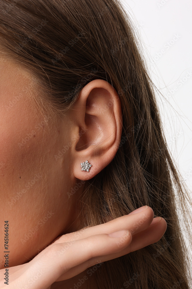 Beautiful young girl with fresh healthy skin. Woman advertise ear-rings. White background. Earrings closeup. Blond european woman with long hair with big lips, pretty smile. Cosmetology, scincare Beautiful young girl with fresh healthy skin. Woman advertise ear-rings. White background. Earrings closeup. Blond european woman with long hair with big lips, pretty smile. Cosmetology, scincare