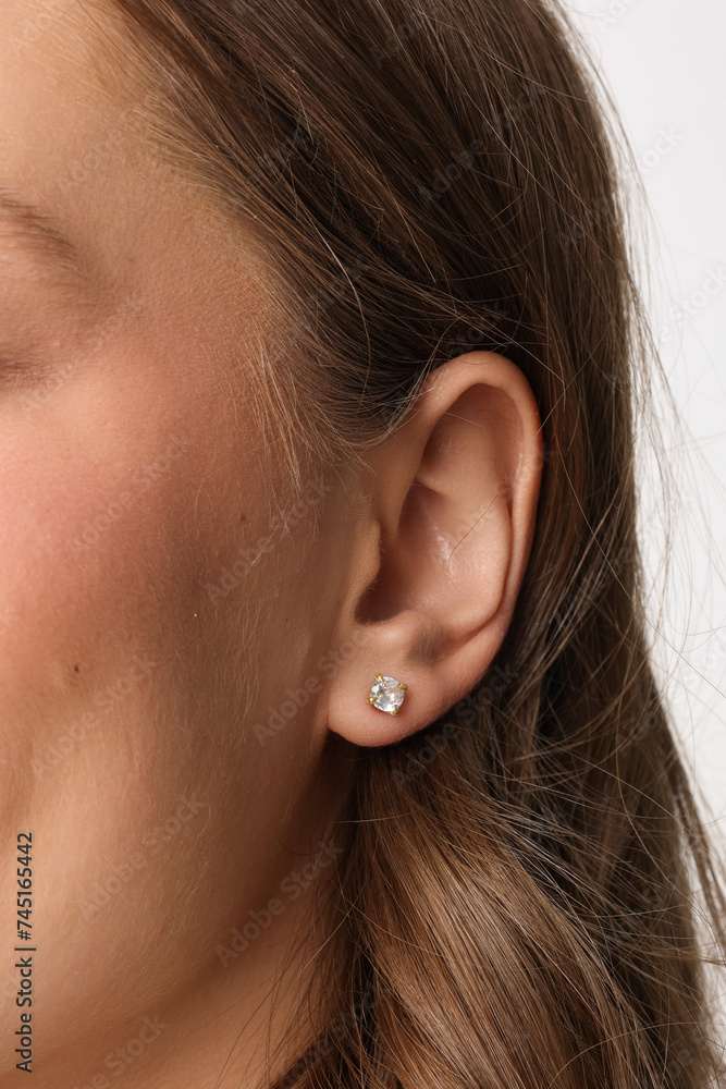 Beautiful young girl with fresh healthy skin. Woman advertise ear-rings. White background. Earrings closeup. Blond european woman with long hair with big lips, pretty smile. Cosmetology, scincare Beautiful young girl with fresh healthy skin. Woman advertise ear-rings. White background. Earrings closeup. Blond european woman with long hair with big lips, pretty smile. Cosmetology, scincare