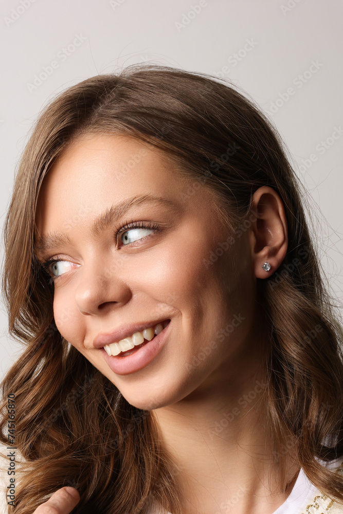 Beautiful young girl with fresh healthy skin. Woman advertise ear-rings. White background. Earrings closeup. Blond european woman with long hair with big lips, pretty smile. Cosmetology, scincare Beautiful young girl with fresh healthy skin. Woman advertise ear-rings. White background. Earrings closeup. Blond european woman with long hair with big lips, pretty smile. Cosmetology, scincare